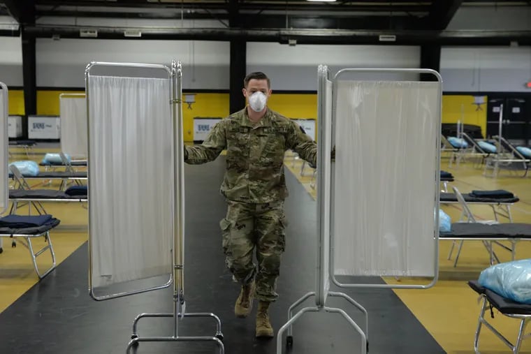 The 103rd Brigade Engineer Battalion out of Fort Mifflin partially breaks down the unused temporary hospital set up at the Glen Mills Schools in Delaware County. Local officials are confident of enough hospital capacity without it.