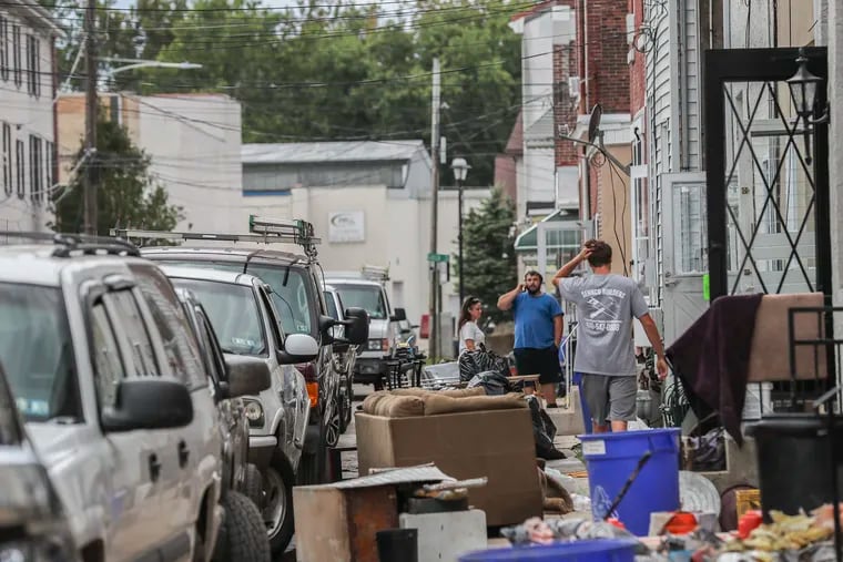 In Bridgeport, residents along Second Street cleaned out their flooded homes on Sept. 3.