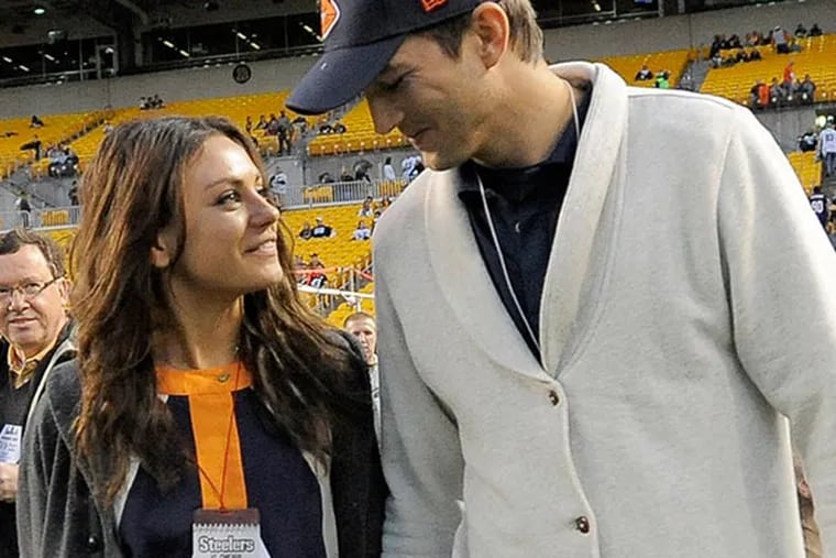 Ashton Kutchar, right, and Mila Kunis walk along the sideline before the NFL football game between the Pittsburgh Steelers and the Chicago Bears at Heinz Field on Sunday, Sept. 22, 2013, in Pittsburgh. (AP Photo/Keith Srakocic)