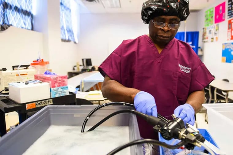 Kofi Poku cleans a pediatric colonoscope at Berkeley College in Clifton, N.J. "People will skip steps," he said.