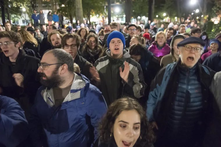 Mourners sing in Philadelphia's Rittenhouse Square during a vigil Saturday night to honor the victims of the shooting at The Tree of Life Congregation in Pittsburgh.