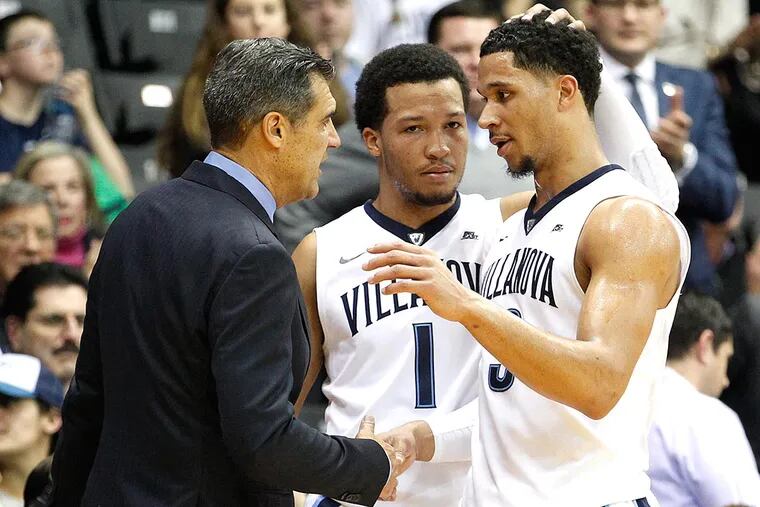 Josh Hart (right) is congratulated by head coach Jay Wright (left) and teammate Jalen Brunson as he is removed from the game.