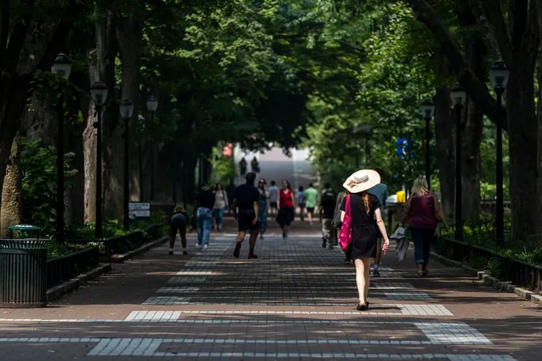 People and students walking along Locust Walk on the University of Pennsylvania’s campus in June.