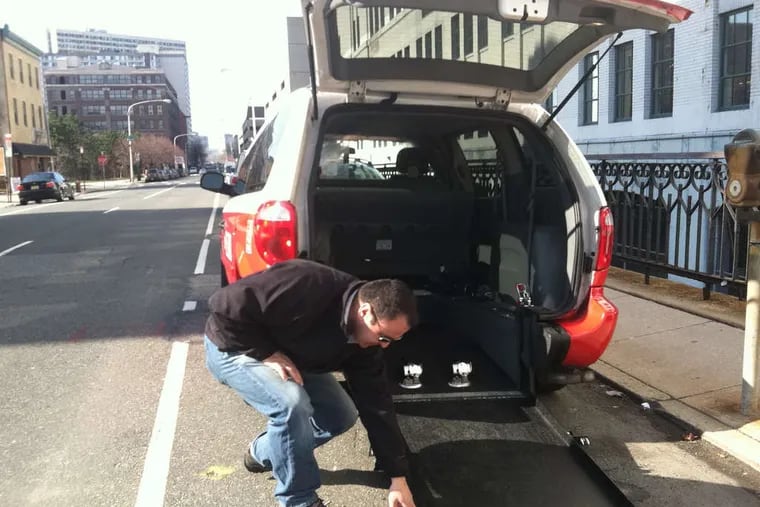 Refik Kalyoncu demonstrates his wheelchair-accessible cab, one of only three in the city. The city aims to phase them in.