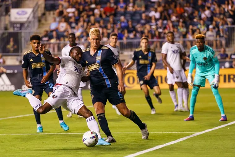 D.C. United's Chris Odoi-Atsem, front left, looks for a shot against Philadelphia Union's Jakob Glesnes during the second half of an MLS soccer match Friday, July 8, 2022, in Chester, Pa. (AP Photo/Chris Szagola)
