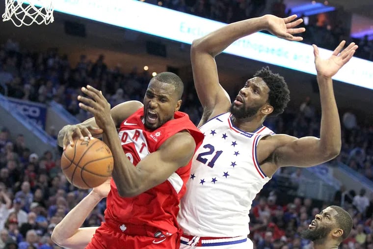 Toronto's Serge Ibaka pulls down a rebound during Game 4 of the Eastern Conference Semifinals on Sunday. The Raptors beat the Sixers, 101-96, to tie the series at two.