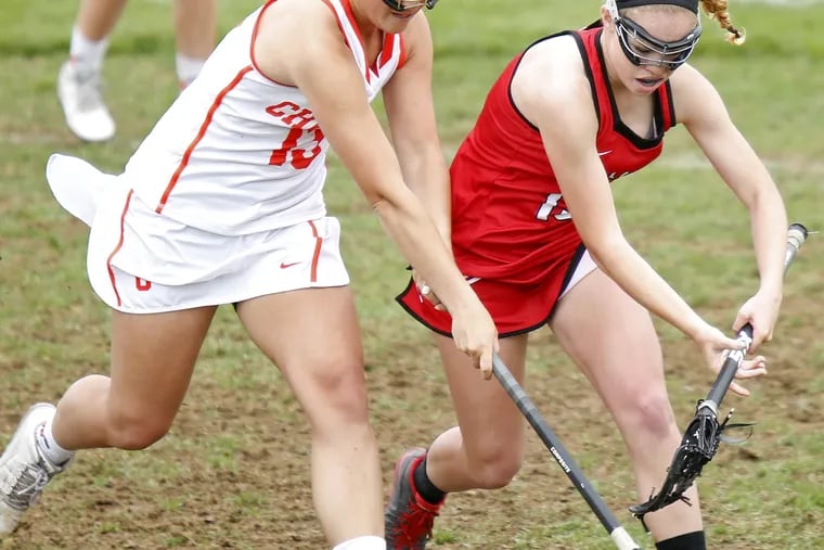 Cherokee's Christina Orio (left) beats Lenape's Allison Cowan to a loose ball during the first half of a girls' lacrosse game Saturday, April 29, 2017 at Cherokee. Lenape went on to win, 18-8. LOU RABITO / Staff