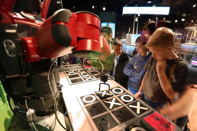 Students from Sunnyside Intermediate School in Lafayatte, Ind., play tic-tac-toe with Baxter the robot on May 19, 2015 at the Museum of Science and Industry in Chicago. The museum will be home to &quot;Robot Revolution,&quot; a national touring exhibit that opened on May 21, 2015.