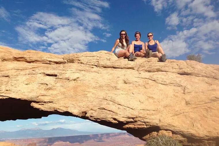 Myself (far left) and Melissa Ballentine (center) and Laura Ballentine atop the Mesa Arch in Canyonlands National Park in September, 2014.