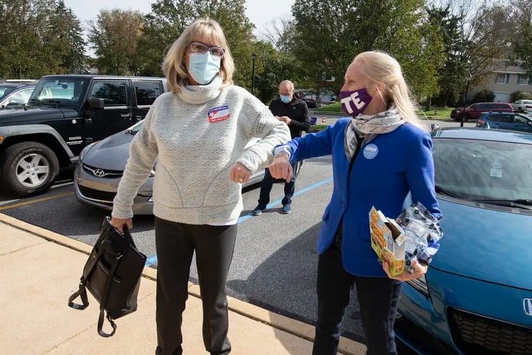 Congresswoman Mary Gay Scanlon, right, greets poll worker, Patti Ischiropoulos, as she arrives at a polling location in Brookhaven, Delaware County, PA on Nov. 3, 2020. Scanlon sits on a Congressional committee with oversight on how the Biden administration enacts regulations.