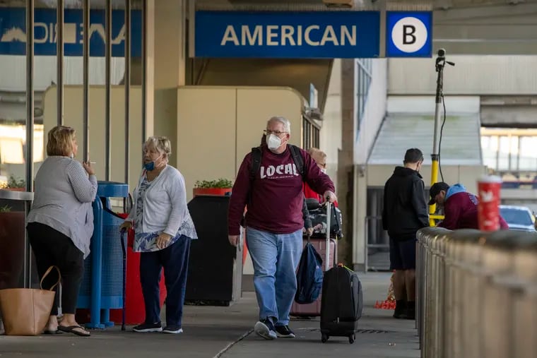 Travelers outside American Airlines' Terminal B at Philadelphia International Airport last month.