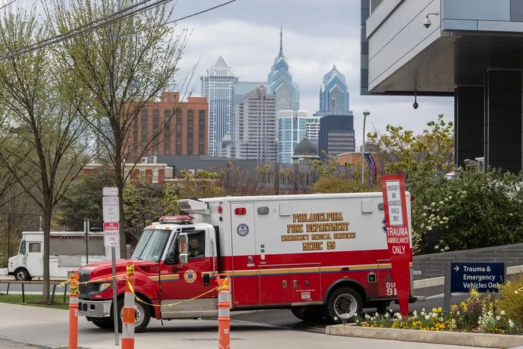 An ambulance leaves the emergency room at Penn Presbyterian Medical Center in April 2020.