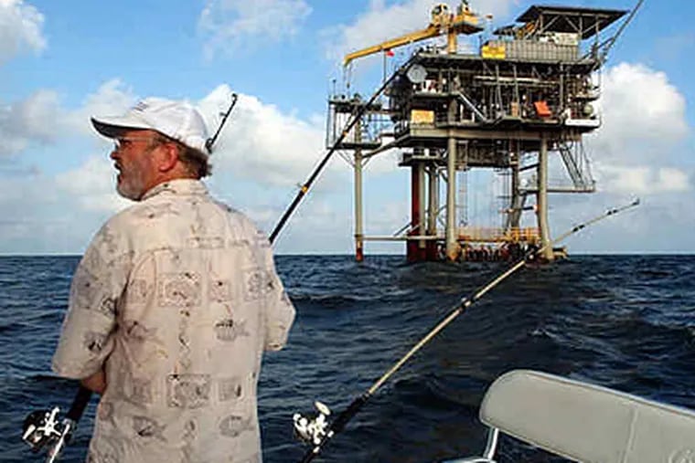 A fisherman plies the waters of the Gulf of Mexico near a natural-gas well near Gulf Shores, Ala. President Obama's plan would open an area off the coast of Virginia to exploration. (Dave Martin / Associated Press)