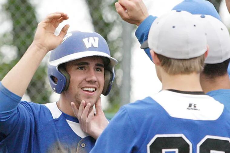 Williamstown's Matt Lang is greeted by teammates after he scored Williamstown's second run of the game in the fifth inning. (Elizabeth Robertson/Staff Photographer)