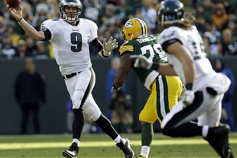 Eagles quarterback Nick Foles throws to Riley Cooper during the first half against the Packers. (Mike Roemer/AP)