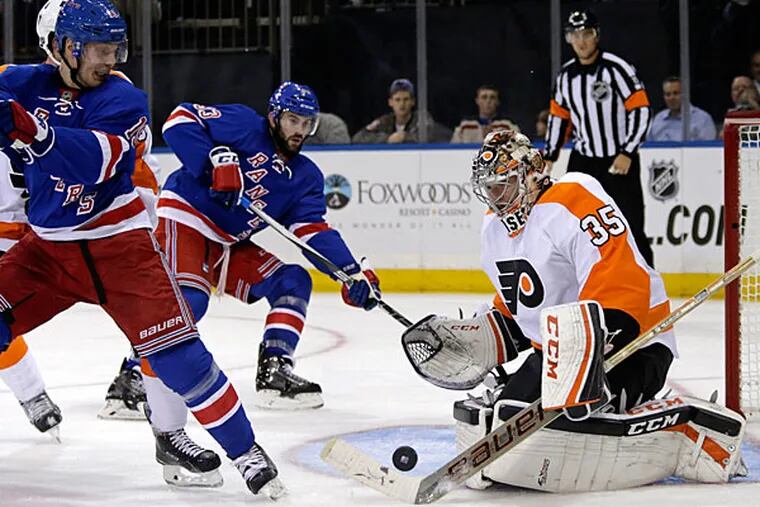 Philadelphia Flyers goalie Steve Mason (35) makes a save in front of
New York Rangers right wing Jesper Fast (19) during the second period
of an NHL preseason hockey game at Madison Square Garden in New York, Monday, Sept. 28, 2015.