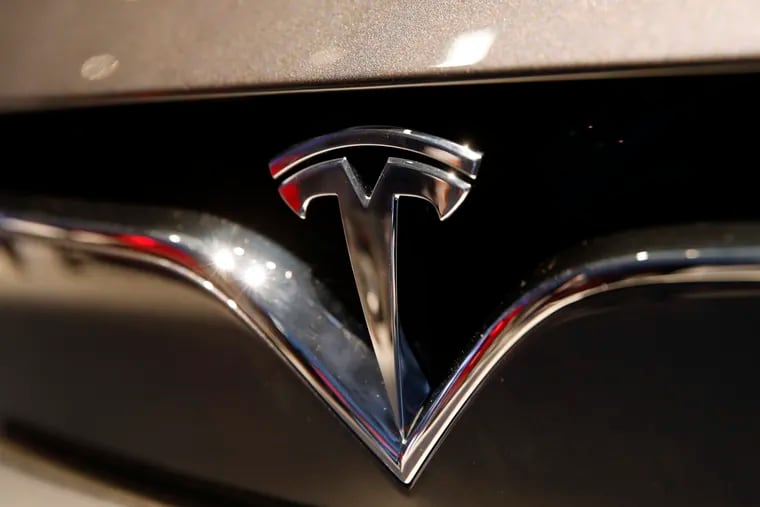FILE - The Tesla logo. Tesla CEO Elon Musk appears poised to transform the company’s electric cars into driverless vehicles in a risky bid to realize a bold vision that he has been floating for years.