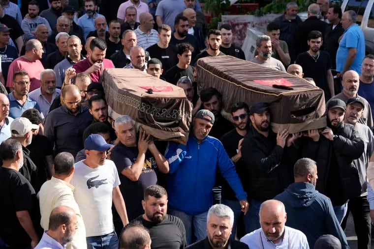 Mourners carry the coffins of two victims who were among four civilians from the same family killed on Sunday by Israeli strikes on the southern town of Mays al-Jabal, during their funeral procession on Monday, May 6, 2024.