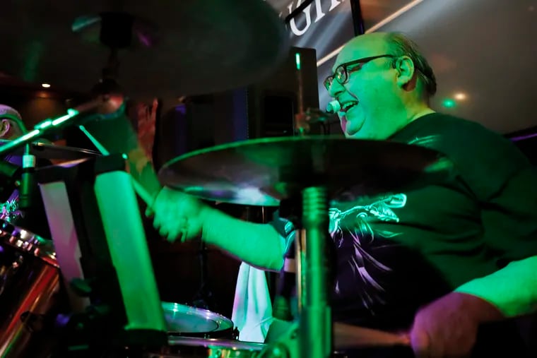 Mike Juliano of the Juliano Brothers cover band plays the drums at the Laughing Fox Tavern in Magnolia, N.J., last week.
