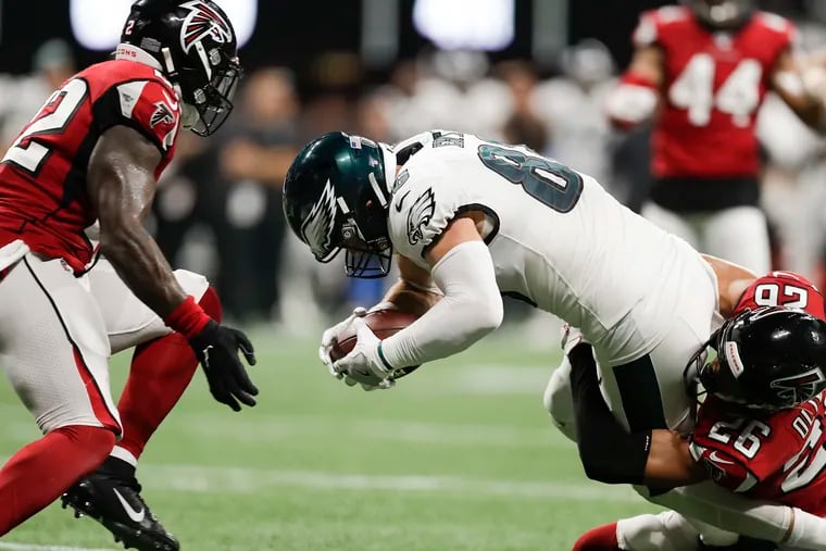 Eagles tight end Zach Ertz reaches for the first down late in the fourth quarter against Atlanta Falcons cornerback Isaiah Oliver (right) and strong safety Keanu Neal.