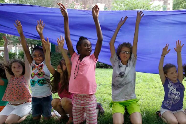 Child actors rehearse their role as water with the help of blue fabric for Shakespeare in Clark Park's &quot;The Winter's Tale.&quot; They play a key role in the show. (Photo: Michael Bryant / Staff Photographer)