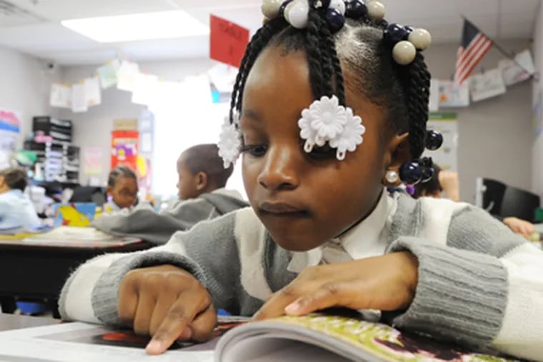 First grader Makayla Barrett works on her reading. Critics challenge the school's academic achievements, especially in light of a state probe of possible state test score cheating. (Clem Murray / Staff Photographer)