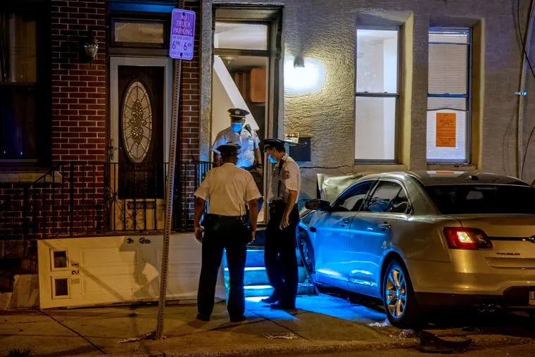 Police inspect a crash at 35th and Mt. Vernon Streets overnight Aug. 27, 2020, where two women were killed and a 14 year-old girl was injured when a car jumped the curb earlier.