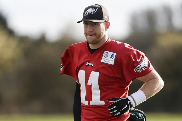 Eagles quarterback Carson Wentz leaves the field after the team practiced at the London Irish training ground in Southwest London on Friday, October 26, 2018.