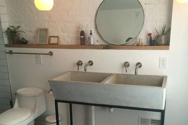 Melissa and John Lattanzio wanted a modern renovation to their Old Kensington row home, one with vintage touches like exposed brick and beams, claw-foot tubs and warm industrial lighting.