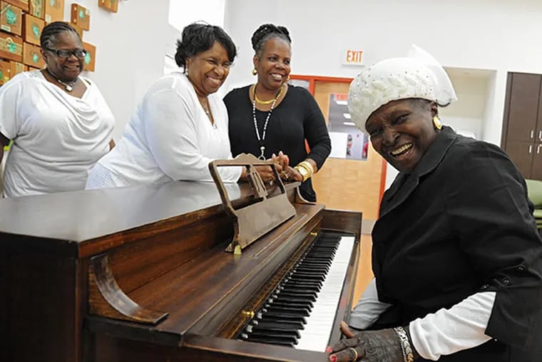 Janie Walker, 79, laughs at the end of a song she played at the New Courtland LIFE center June 4, 2014.  The piano in the center, located at 19th and W. Allegheny, was rescued from a neighborhood trash heap and refurbished by an executive of New Courtland. Ms. Walker lives in the Strawberry Mansion neighborhood.  ( CLEM MURRAY / Staff Photographer )