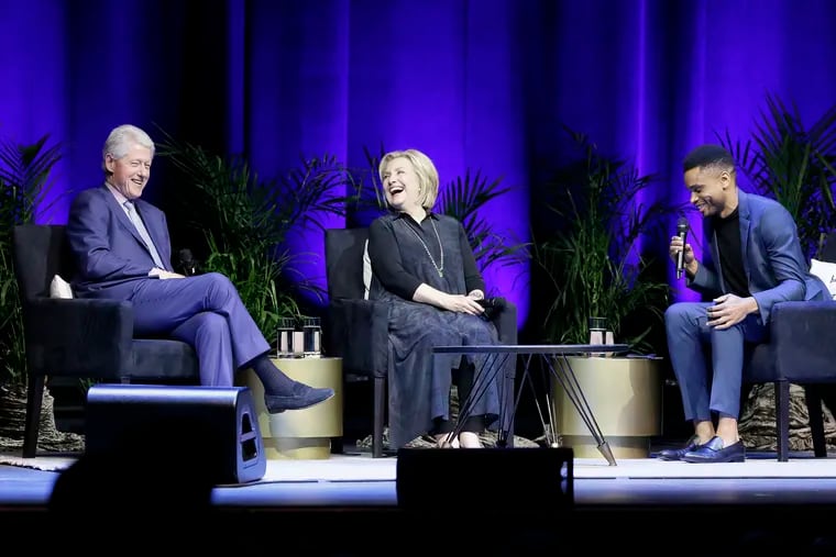 (Left to right:) Former President Bill Clinton, former Secretary of State Hillary Rodham Clinton, and moderator Nnamdi Asomugha (a former Eagle) share a laugh at The Met in Philadelphia on April 13, 2019.