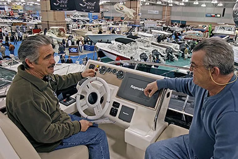 Tom Wall from Atlantic Highland, N.J., (left) and Ken DiGangi, from Middletown, sit atop an Italian-made $600,000 Azimut 38 Flybridge pleasure boat Thursday at the Boat Show in Atlantic City. (Akira Suwa / Staff Photographer)