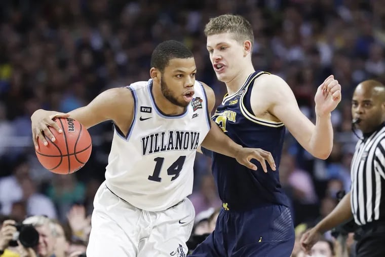 Omari Spellman dribbles past Michigan's Moritz Wagner during Villanova's win over the Wolverines in the NCAA tournament title game in April.