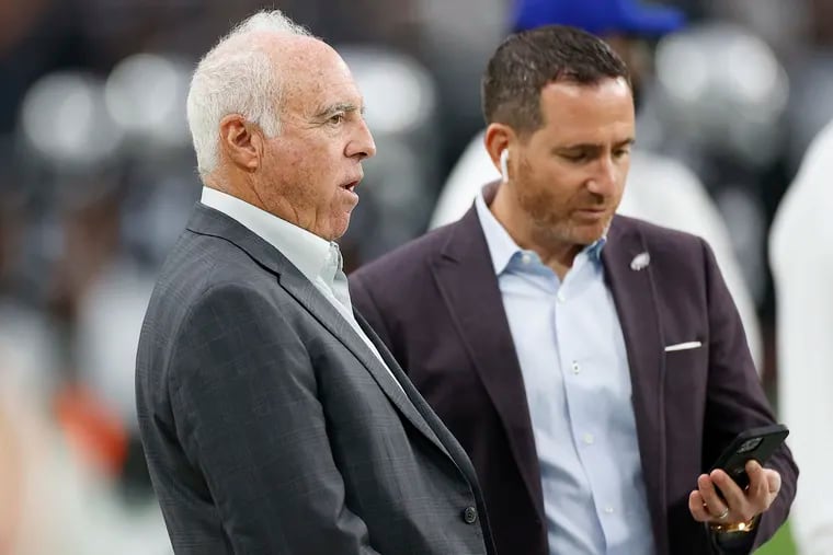Eagles Chairman and Chief Executive Officer Jeffrey Lurie with team Executive Vice President/General Manager Howie Roseman looking down at his mobile phone before the Eagles played Las Vegas Raiders on Sunday, October 24, 2021 in Las Vegas.