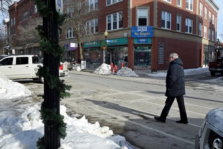 Mayor Jim Kenney walks in downtown Laconia, beginning his day on the stump as a surrogate for Mass. Sen. Elizabeth Warren's presidential campaign in New Hampshire Jan. 21, 2020. On the corner is the  Belknap County field office of candidate Pete Buttigieg.