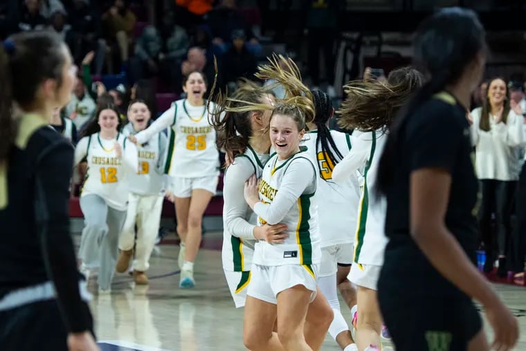 Lansdale Catholic’s Olivia Boccella (center) celebrates a 50-47 win over Archbishop Wood at the Palestra on Feb. 27. It was the Crusaders' first Philadelphia Catholic League title.