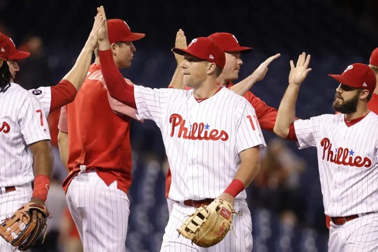 The Philadelphia Phillies’ Rhys Hoskins, center, celebrates the win with teammates after a baseball game against the Atlanta Braves on Monday. The teams’ game Tuesday then was rained out.