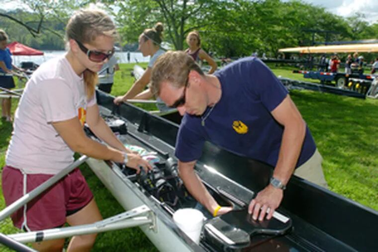 Philadelphia University crew coach Chris O&#0039;Brien helps sophomore Lauren Hendel prepare the women&#0039;s novice eight shell.