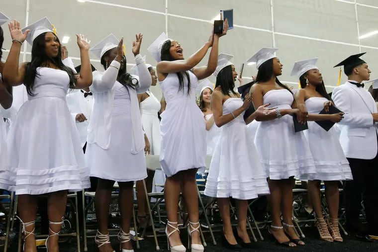 Graduates of Cristo Rey Philadelphia High School applaud their parents at the end of the ceremony in 2018. The school is a private Catholic college preparatory school funded by philanthropists and business leaders for underserved children of all faiths.