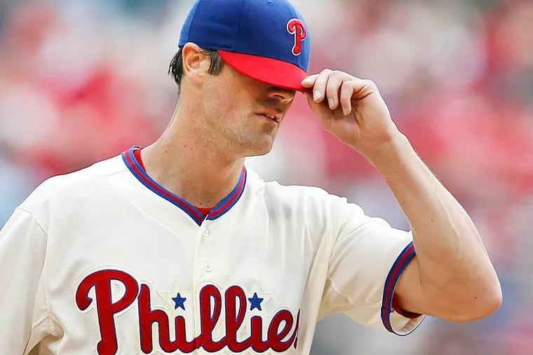 Phillies' Cole Hamels adjusts his cap after giving up a two-run homer to Cleveland Indians' Nick Swisher in the 5th inning at Citizens Bank Park in Philadelphia, Pennsylvania, Wednesday, May 15, 2013. (David Maialetti/Philadelphia Daily News/MCT)