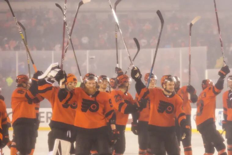 The Flyers raising their sticks after rallying dramatically to beat the Penguins in overtime, 4-3, during the Stadium Series game at Lincoln Financial Field on Feb. 23.
