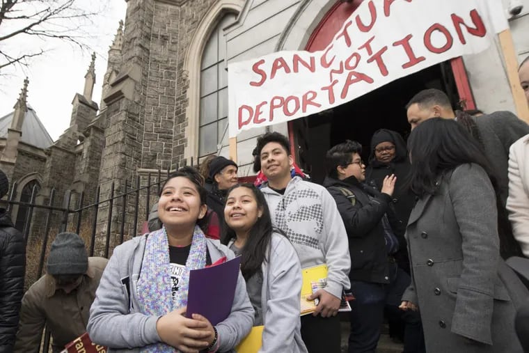 Three children of Carmela Apolonio Hernandez – Yoselin, 11, left; Keyri, 13; and Fidel, 15 – smile as they make their way out of the Church of the Advocate to attend public school in Philadelphia. The family entered church sanctuary to avoid deportation.