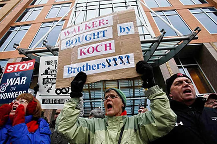Union supporters demonstrate in front of Koch Industries HQ in Madison, Wisc., last week. (Associated Press)