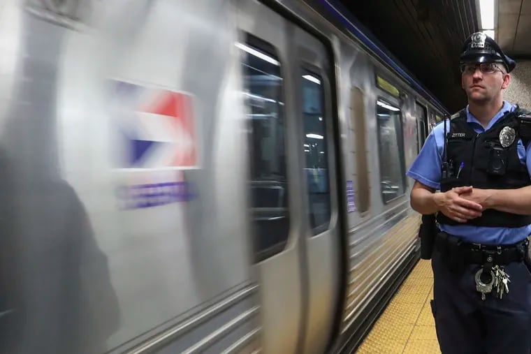 SEPTA police officer Martin Zitter waits as the El train arrives at 13th street station in Philadelphia on Wednesday, May 31, 2023.