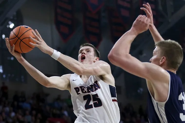 Penn forward AJ Brodeur (25) attempts a shot against Yale forward Blake Reynolds (32) during their Ivy League tournament semifinal game at the Palestra on Saturday, March 10, 2018. TIM TAI / Staff Photographer