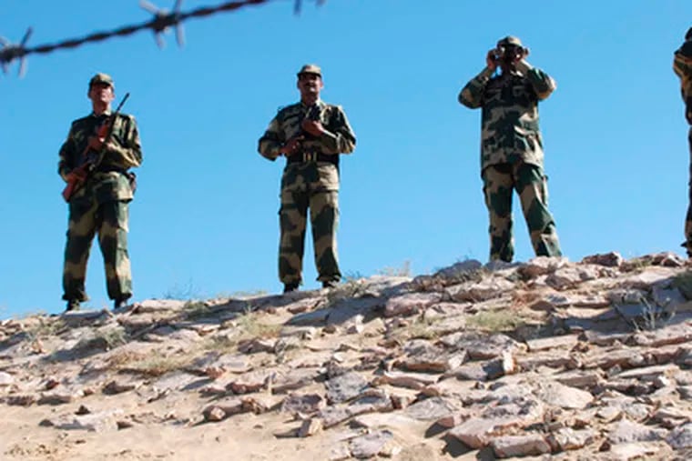 Indian soldiers keep watch along the border at Ranjitpura, India. New Delhi warned Pakistan about its troop buildup.
