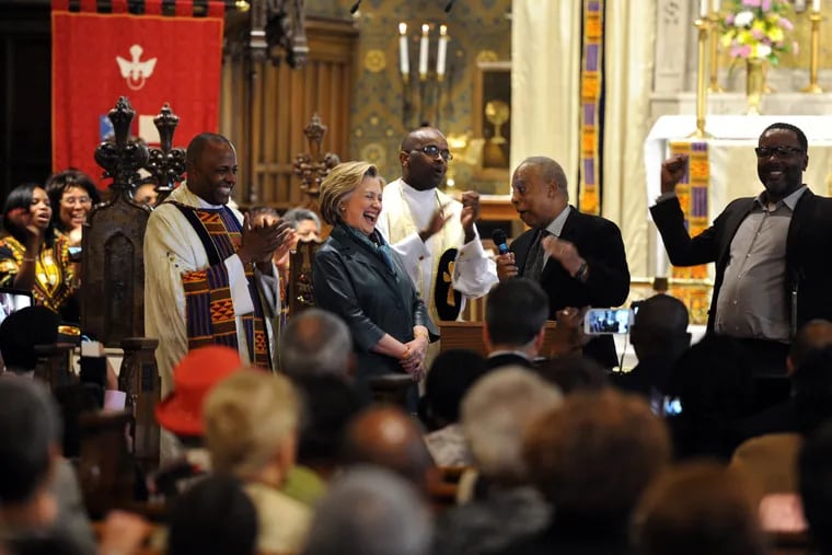 Hillary Clinton laughs with the Rev. Martini Shaw (left) at African Episcopal Church of St. Thomas in Overbrook.
