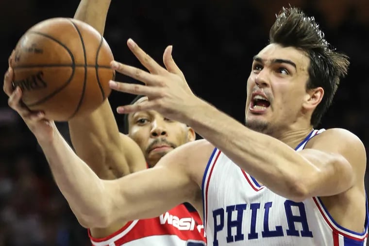 Sixers' forward Dario Saric shoots over Wizards'  forward Otto Porter Jr. during Philadelphia's 120-112 win against Washington on Friday. Saric scored 20 points and grabbed 11 rebounds in the victory.