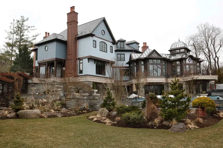 The back of the house , a 13,000-square-foot manse in Gladwyne, shows off the added conservatory. Its former owner was filmmaker M. Night Shyamalan.