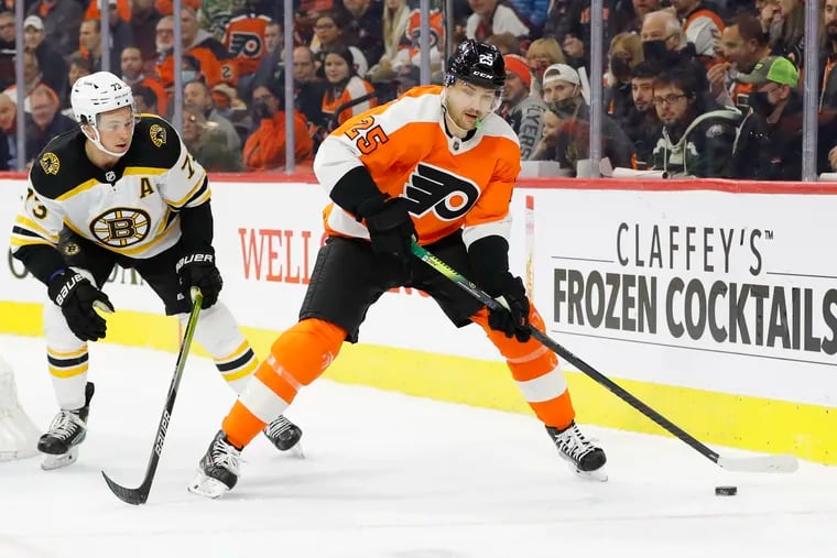Flyers left winger James van Riemsdyk skates with the puck against Boston Bruins defenseman Charlie McAvoy on Saturday. Van Riemsdyk is off to a slow start this season.